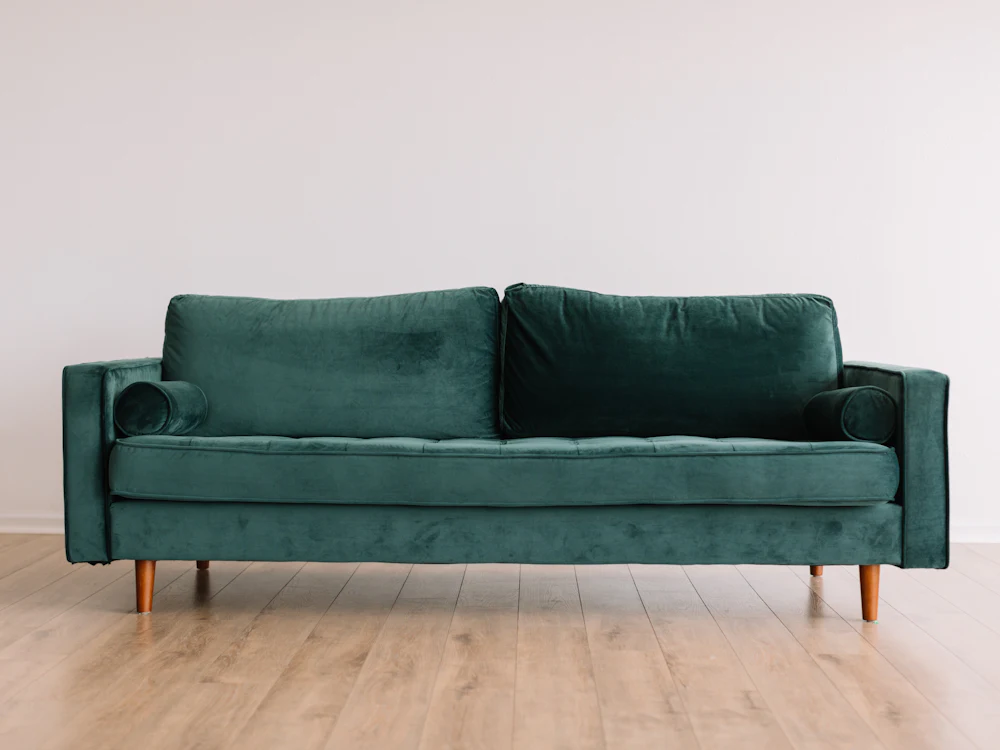 Green velvet three-seater sofa